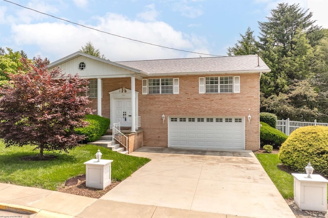 330 Baldwin St, Morgantown, WV 26505 - bi-level home featuring brick siding, a garage, driveway, and roof with shingles
