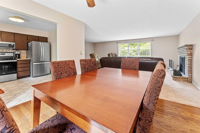 101 Forest Dr, Morgantown, WV 26505 - dining area featuring light wood-type flooring and a brick fireplace