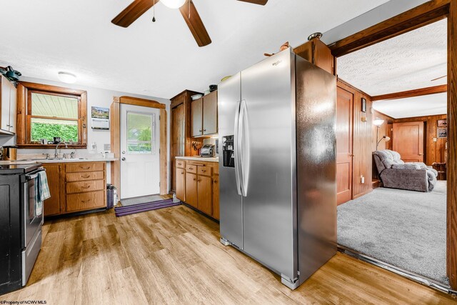 14318 N Preston Hwy, Bruceton Mills, WV 26525 - kitchen with appliances with stainless steel finishes, light countertops, light wood-style floors, and a textured ceiling