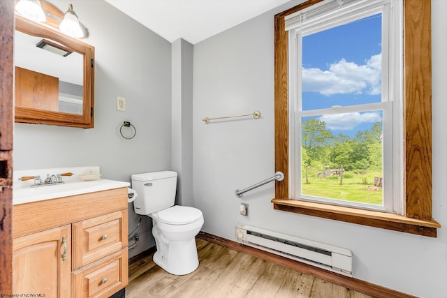 14318 N Preston Hwy, Bruceton Mills, WV 26525 - half bathroom with baseboard heating, vanity, toilet, wood finished floors, and baseboards