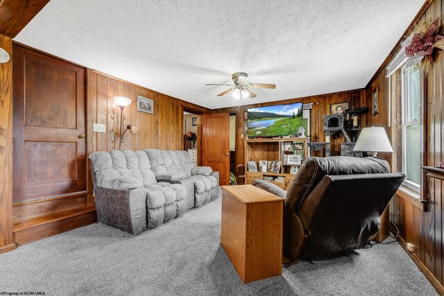 14318 N Preston Hwy, Bruceton Mills, WV 26525 - carpeted living room featuring wood walls, a ceiling fan, and a textured ceiling