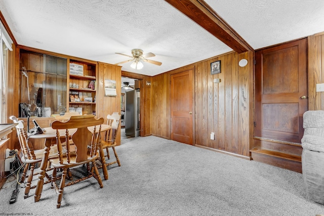 14318 N Preston Hwy, Bruceton Mills, WV 26525 - dining room featuring a textured ceiling, ceiling fan, wooden walls, and carpet flooring