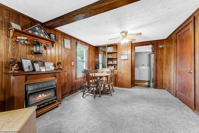14318 N Preston Hwy, Bruceton Mills, WV 26525 - carpeted dining space featuring separate washer and dryer, wood walls, a textured ceiling, ceiling fan, and a glass covered fireplace
