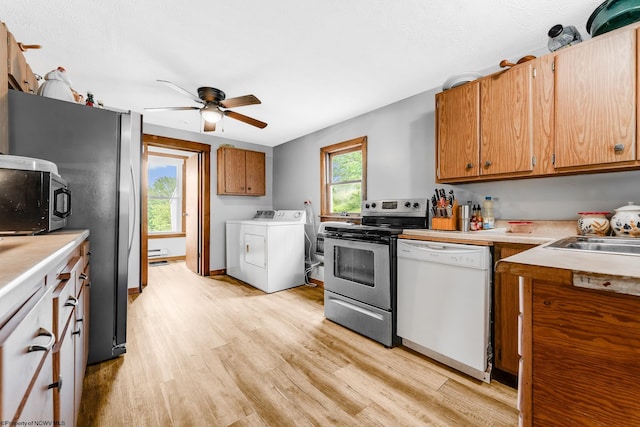 14318 N Preston Hwy, Bruceton Mills, WV 26525 - kitchen with stainless steel appliances, separate washer and dryer, light wood-style floors, and light countertops