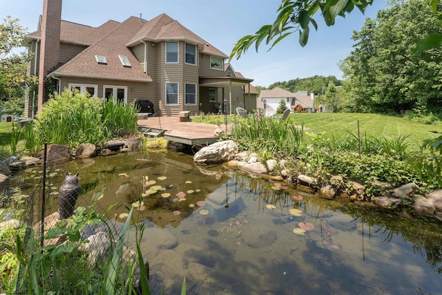 1300 Deer Run, Morgantown, WV 26508 - rear view of property featuring a garden pond, a deck, roof with shingles, and a chimney