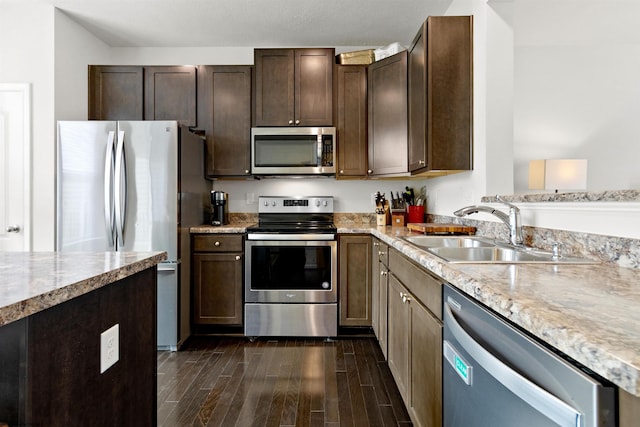 119 Inlet St, Morgantown, WV 26508 - kitchen with appliances with stainless steel finishes, a sink, dark wood-style floors, dark brown cabinetry, and light stone counters