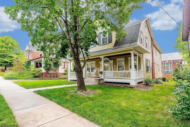 244 Grand St, Morgantown, WV 26501 - view of front of property with roof with shingles, a porch, a front yard, and central AC unit