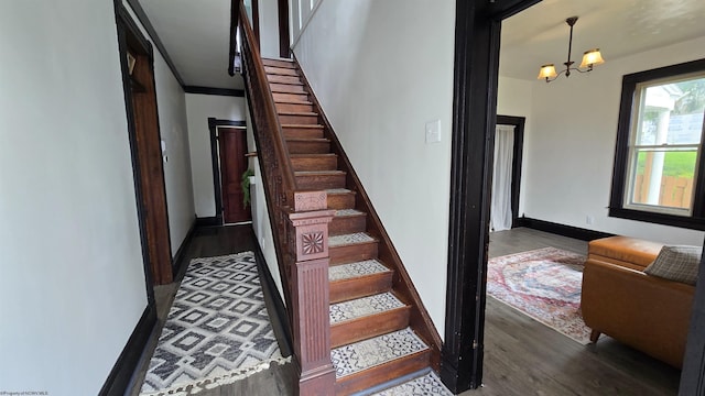 92 N High St, Philippi, WV 26416 - stairway with wood finished floors, baseboards, a chandelier, and crown molding
