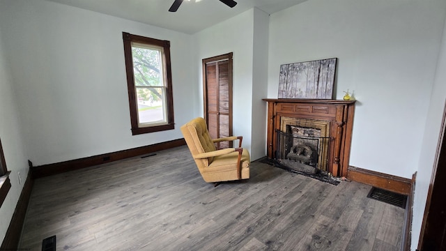 92 N High St, Philippi, WV 26416 - living area featuring wood finished floors, baseboards, ceiling fan, and a fireplace
