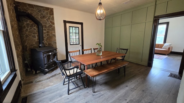 92 N High St, Philippi, WV 26416 - dining space with a wood stove, wood finished floors, and ornamental molding