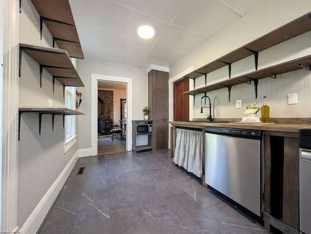92 N High St, Philippi, WV 26416 - kitchen featuring open shelves, stainless steel dishwasher, a sink, baseboards, and a paneled ceiling