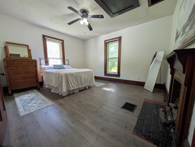 92 N High St, Philippi, WV 26416 - bedroom with wood finished floors, baseboards, a fireplace, and ceiling fan