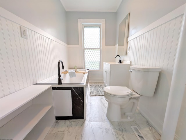 92 N High St, Philippi, WV 26416 - full bath with toilet, vanity, a garden tub, wainscoting, and marble finish flooring