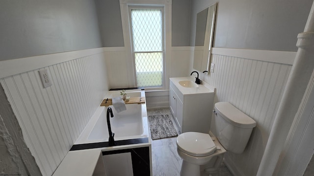 92 N High St, Philippi, WV 26416 - full bathroom featuring toilet, vanity, wainscoting, a tub, and a decorative wall