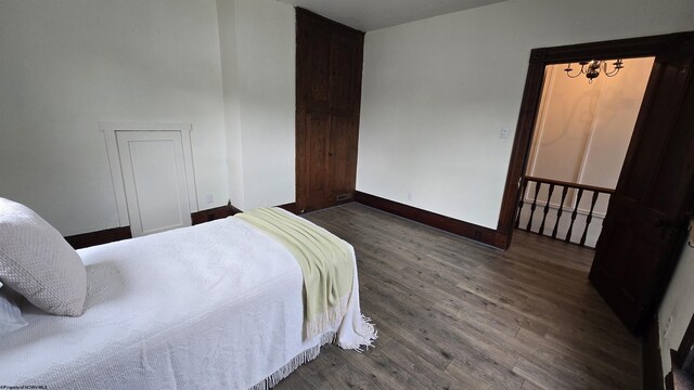92 N High St, Philippi, WV 26416 - bedroom with a chandelier, wood finished floors, and baseboards