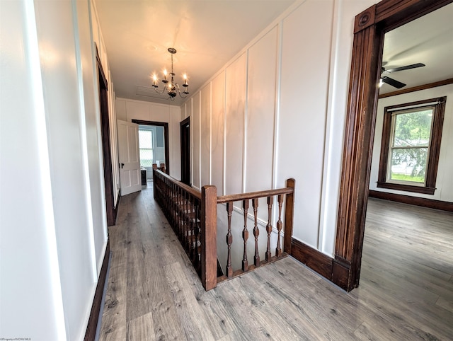 92 N High St, Philippi, WV 26416 - hall featuring a chandelier, a decorative wall, wood finished floors, ornamental molding, and baseboards