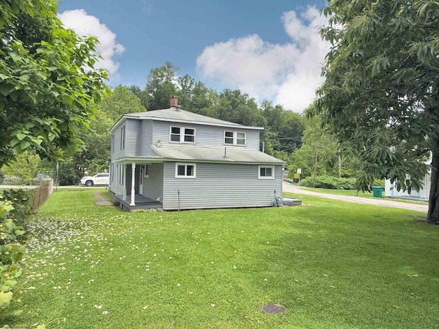 60 Sidetrack Rd Unit 2, Flemington, WV 26424 - back of property with a lawn, a chimney, roof with shingles, and view of wooded area