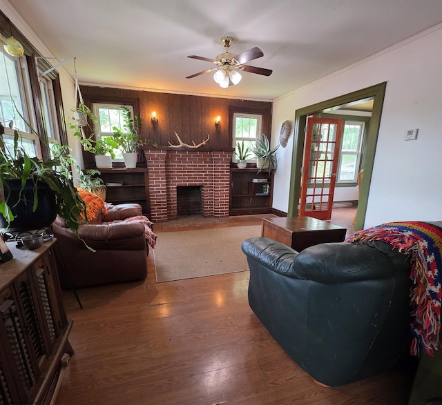 147 E 6th St, Weston, WV 26452 - living area with wood finished floors, healthy amount of natural light, ceiling fan, a fireplace, and wooden walls