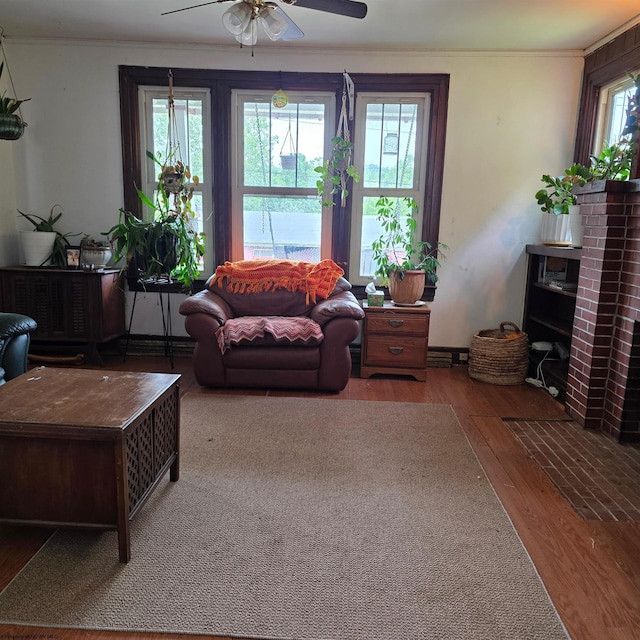 147 E 6th St, Weston, WV 26452 - living area with wood finished floors, ceiling fan, ornamental molding, and a fireplace