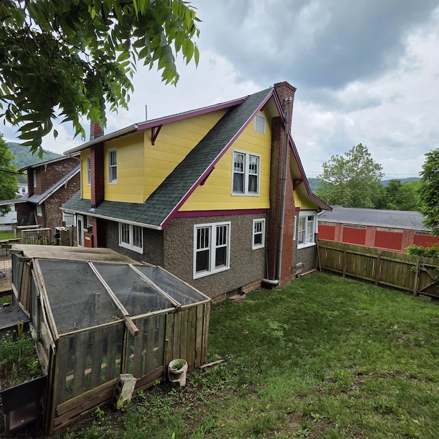 147 E 6th St, Weston, WV 26452 - back of property featuring a chimney, roof with shingles, and an exterior structure