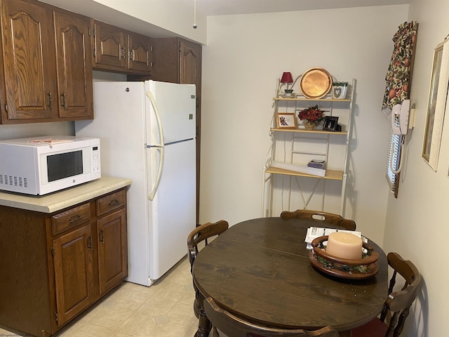 1730 S Davis Ave, Elkins, WV 26241 - kitchen featuring white appliances, light countertops, and dark brown cabinetry
