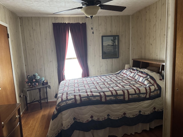 262 Henry Ave, Davis, WV 26260 - bedroom featuring wood walls, wood finished floors, and ceiling fan