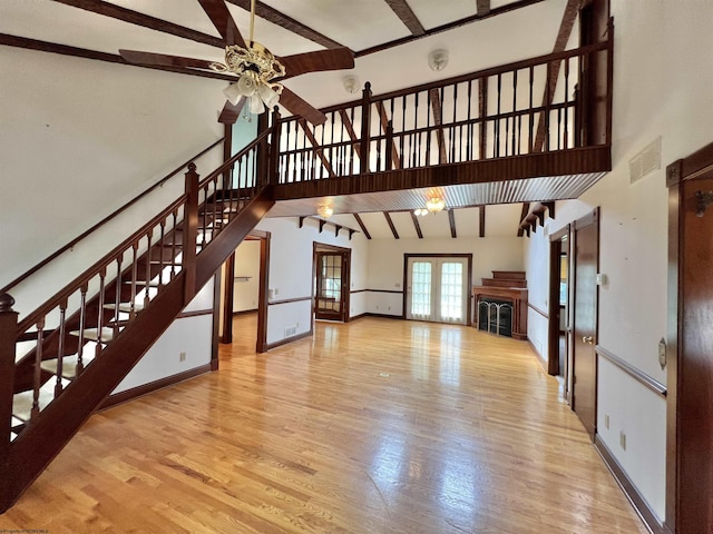 200 Heckle Ln, Elkins, WV 26241 - unfurnished living room featuring a ceiling fan, stairway, beamed ceiling, high vaulted ceiling, and wood finished floors
