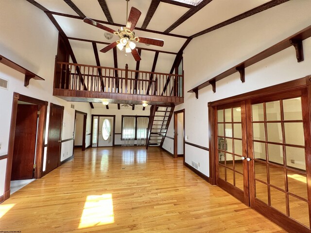 200 Heckle Ln, Elkins, WV 26241 - unfurnished living room featuring french doors, high vaulted ceiling, ceiling fan, wood finished floors, and beam ceiling