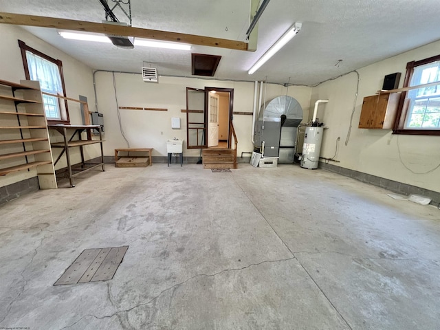 200 Heckle Ln, Elkins, WV 26241 - garage featuring water heater, heating unit, and a garage door opener
