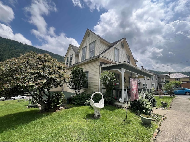 115 Walnut St, Rowlesburg, WV 26425 - view of property exterior featuring covered porch and a lawn