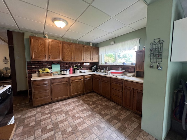 115 Walnut St, Rowlesburg, WV 26425 - kitchen with a drop ceiling, light countertops, brick patterned flooring, stove, and brown cabinets
