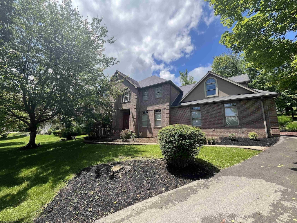 4134 Cove Point Dr, Morgantown, WV 26508 - view of front of home featuring brick siding and a front yard