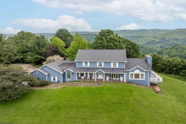 142 Vecchio Ln, Morgantown, WV 26508 - view of front facade featuring a chimney, a front lawn, covered porch, and a wooded view