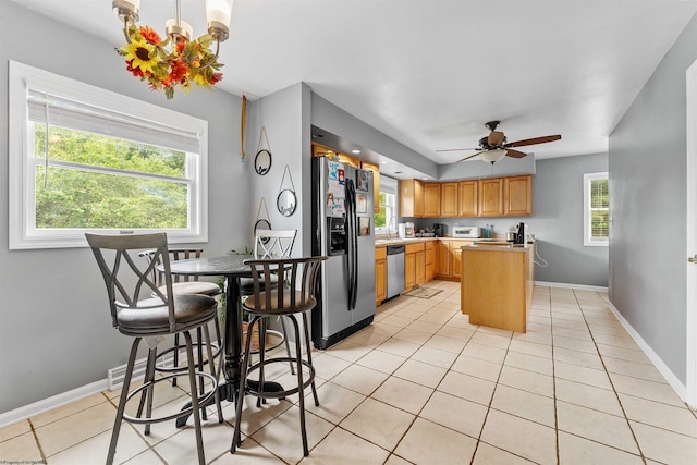 142 Vecchio Ln, Morgantown, WV 26508 - kitchen with stainless steel appliances, ceiling fan, light countertops, and light tile patterned floors