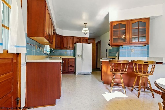 1416 Anmoore Rd, Bridgeport, WV 26330 - kitchen featuring white refrigerator with ice dispenser, a peninsula, tasteful backsplash, glass insert cabinets, and light countertops