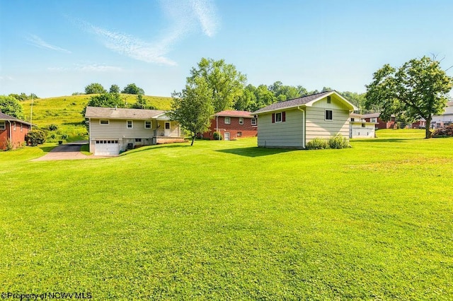 1416 Anmoore Rd, Bridgeport, WV 26330 - view of grassy yard with an attached garage and driveway