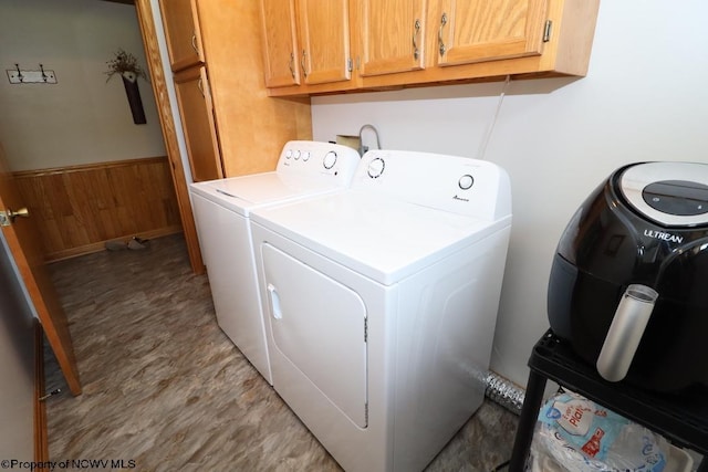 16 Greentree Ln, Elkins, WV 26241 - laundry area featuring cabinet space, washing machine and dryer, a wainscoted wall, and wooden walls