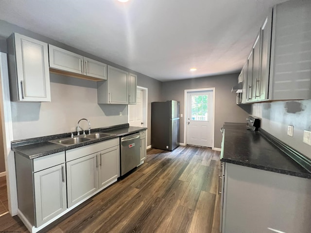 1381 Randall St, Morgantown, WV 26505 - kitchen with appliances with stainless steel finishes, dark wood-type flooring, dark countertops, exhaust hood, and recessed lighting