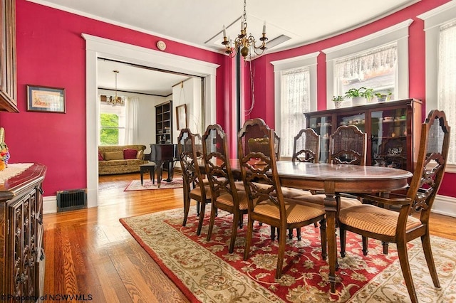 159 E Main St, Clarksburg, WV 26301 - dining space with a chandelier, wood finished floors, and crown molding