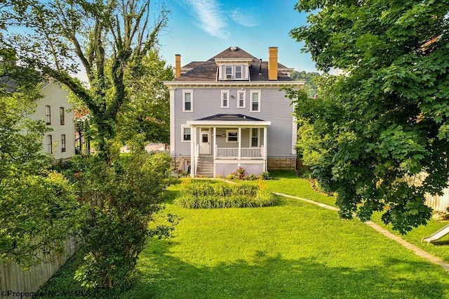 159 E Main St, Clarksburg, WV 26301 - traditional style home with a chimney, a front lawn, and covered porch