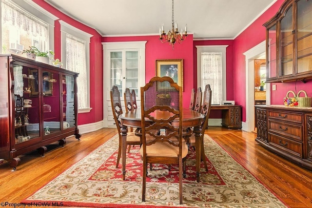 159 E Main St, Clarksburg, WV 26301 - dining area with wood finished floors, a chandelier, and ornamental molding