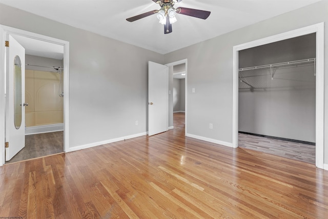 48 Skyline Dr, Morgantown, WV 26508 - unfurnished bedroom featuring wood finished floors, a closet, ensuite bath, and ceiling fan