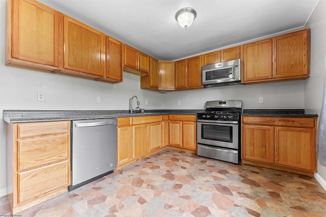 48 Skyline Dr, Morgantown, WV 26508 - kitchen featuring stainless steel appliances, dark countertops, light stone finish floors, and brown cabinets