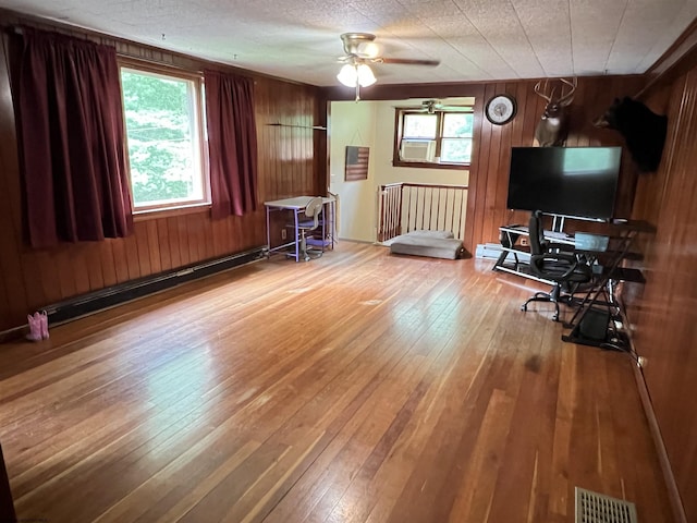 60 Saras Way, Beverly, WV 26253 - living room featuring hardwood / wood-style floors, a baseboard radiator, a ceiling fan, wooden walls, and a desk