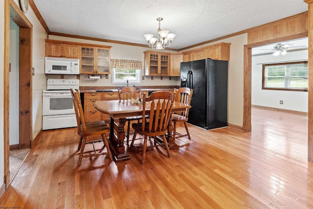 2228 Dinnerbell Five Forks Rd, Farmington, PA 15437 - kitchen with white appliances, crown molding, a chandelier, light wood finished floors, and a textured ceiling