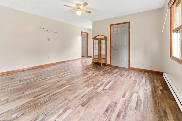 2228 Dinnerbell Five Forks Rd, Farmington, PA 15437 - spare room with a baseboard heating unit, light wood-type flooring, and a ceiling fan