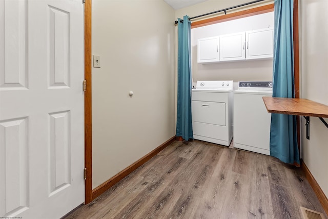 2228 Dinnerbell Five Forks Rd, Farmington, PA 15437 - laundry room featuring washer and clothes dryer, cabinet space, and light wood-style flooring