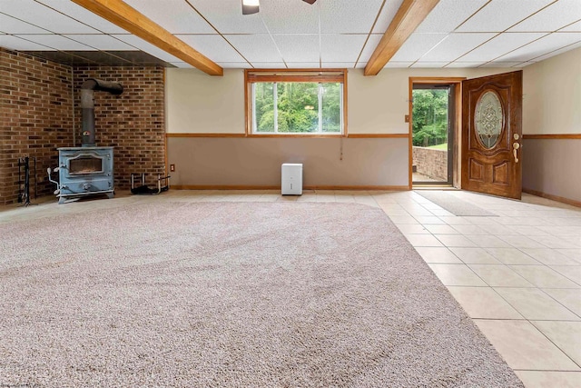 2228 Dinnerbell Five Forks Rd, Farmington, PA 15437 - unfurnished living room with a wood stove, tile patterned flooring, plenty of natural light, and beamed ceiling