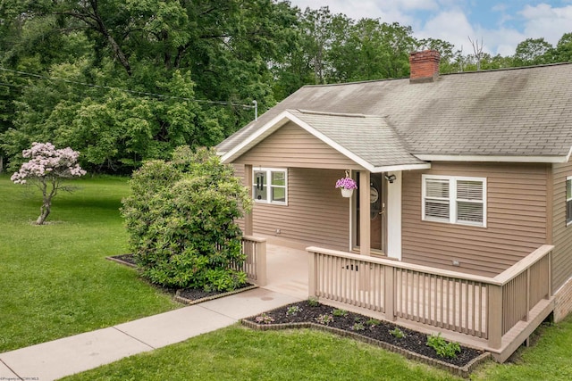 2228 Dinnerbell Five Forks Rd, Farmington, PA 15437 - view of front of house featuring a front lawn, a chimney, and a shingled roof