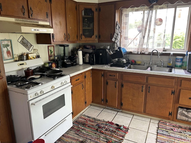 374 Dunkard Ave, Morgantown, WV 26501 - kitchen featuring white gas range, under cabinet range hood, light countertops, and light tile patterned floors